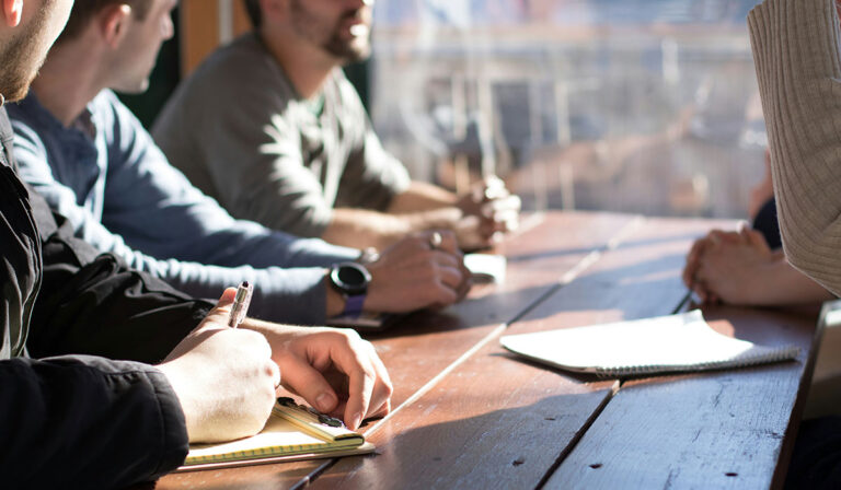 People writing on a desk