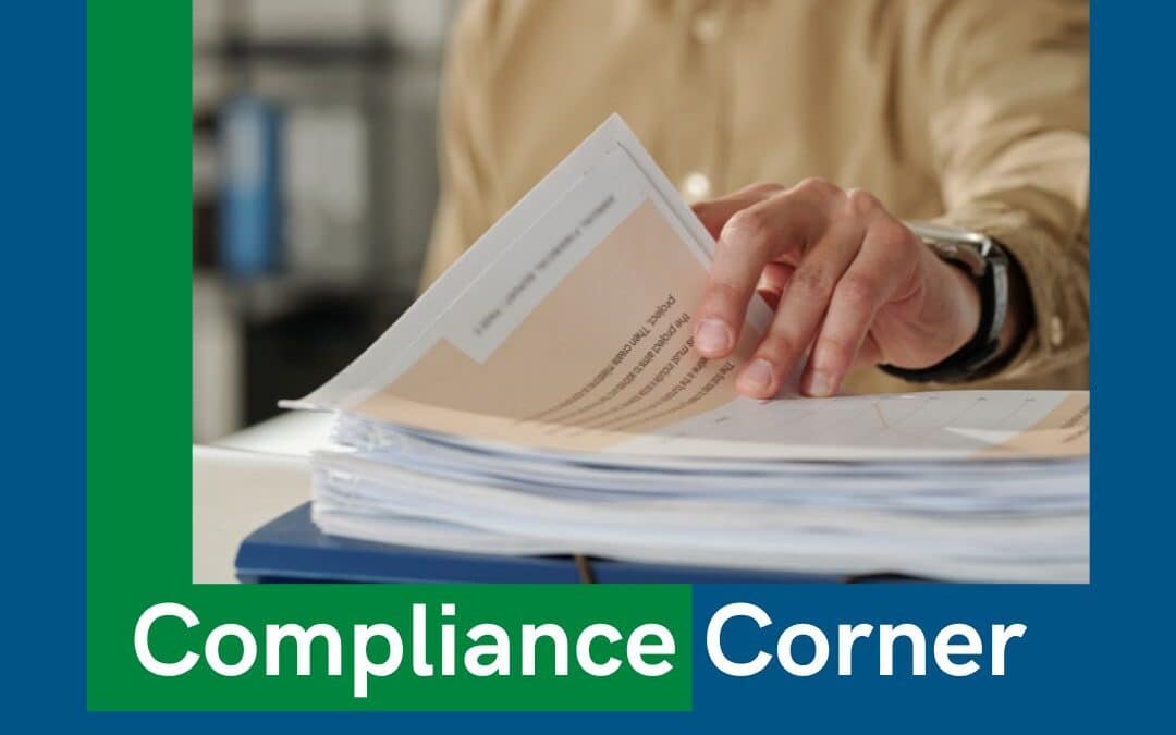 Compliance Corner banner over a photo of a hand flipping through a stack of papers