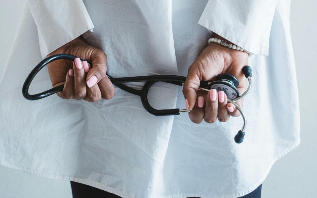 Person Holding Black and Silver Ring