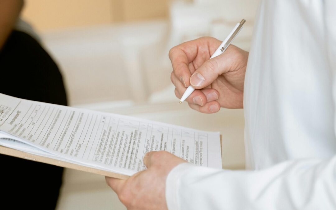 Photo Of Person Holding Paper And Pen