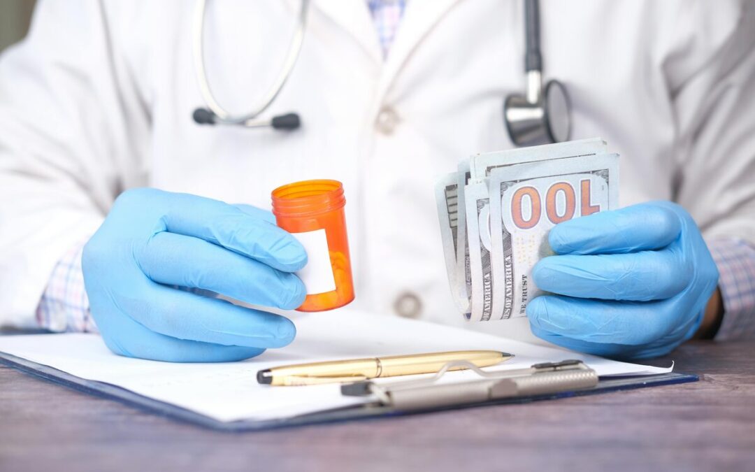 Person Holding Money and Pill Bottle
