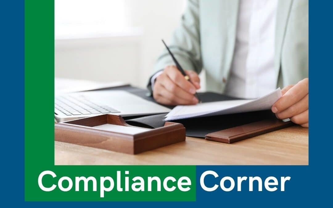Compliance Corner banner over a photo of a hand signing a document at a desk