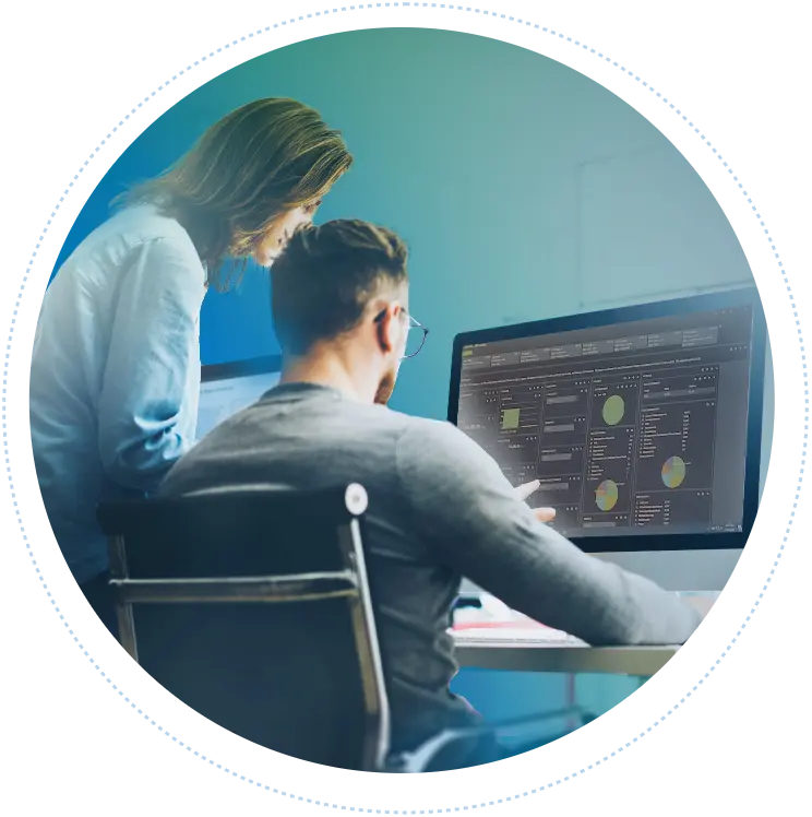 Two colleagues look at a computer dashboard displaying a complete overview of all their tracked data.