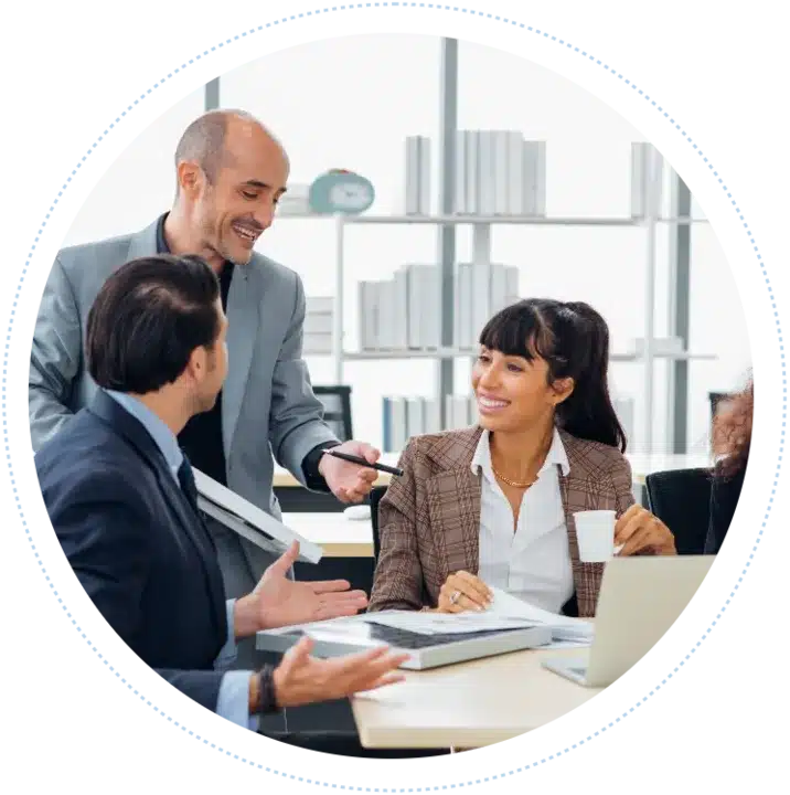 Circular frame showing smiling business professionals in suits collaborating and sharing ideas around a desk in an office